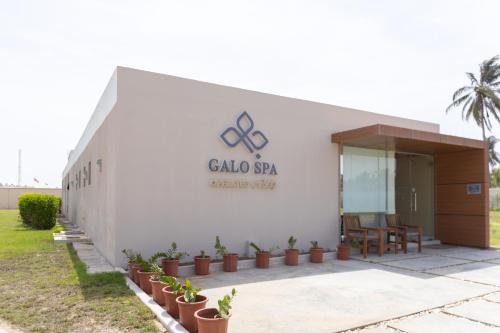 a building with a sign on the side of it at Al Shatti Villas in Salalah
