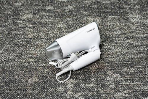 a white inhaler on the floor with a cord at 慶 -Kei- HOTEL LIKE RESIDENCE in Fukuoka