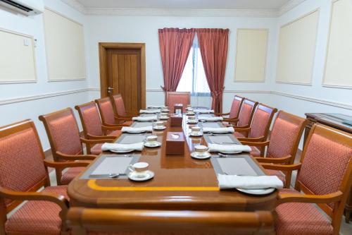 a conference room with a long table and chairs at Al Shatti Villas in Salalah