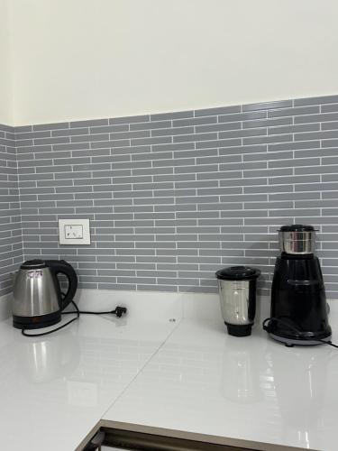 a kitchen counter with two appliances on top of it at Skylands Homes in Calangute
