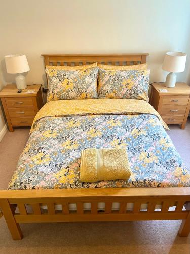 a bedroom with a large bed with two night stands at Luxurious two-bedroom apartment in the centre of Peterborough in Peterborough