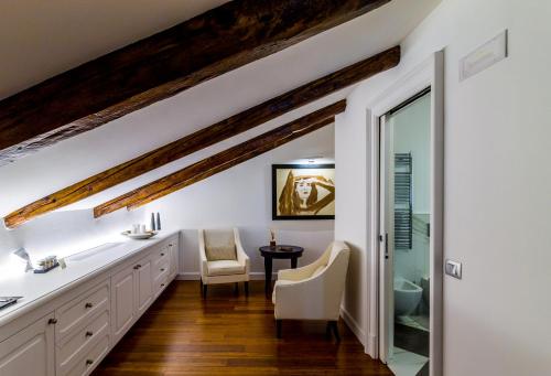 a bathroom with white cabinets and a sink and a mirror at Hotel Villa Fanny in Cagliari