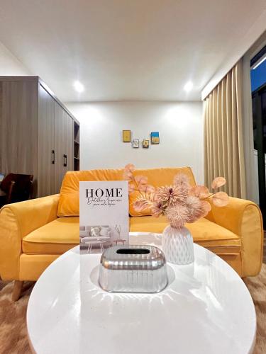 a living room with a couch and a coffee table at HPT Home II Vinhome Marina chuỗi Apartment - Homestay in Hai Phong