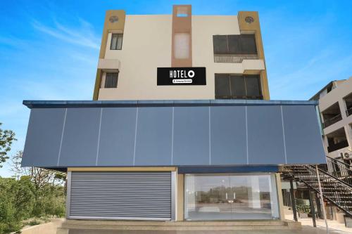 a building with a sign on the front of it at Hotel O Ahmedabad Airport in Ahmedabad