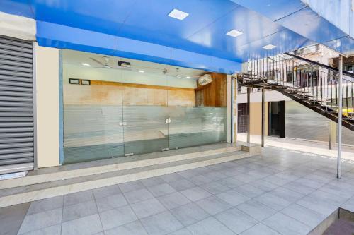 a building with a staircase and a glass wall at Hotel O Ahmedabad Airport in Ahmedabad