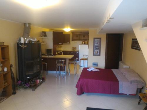a bedroom with a bed and a kitchen with a table at Sweet Sardinia Apartment R2968 in Elmas