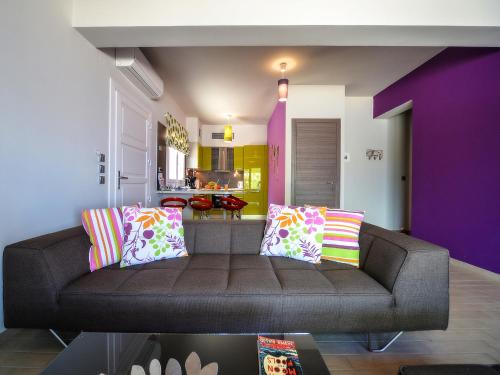 a living room with a couch with colorful pillows at Villa Terra del Nonno with Sea Views & Pool in Gaios