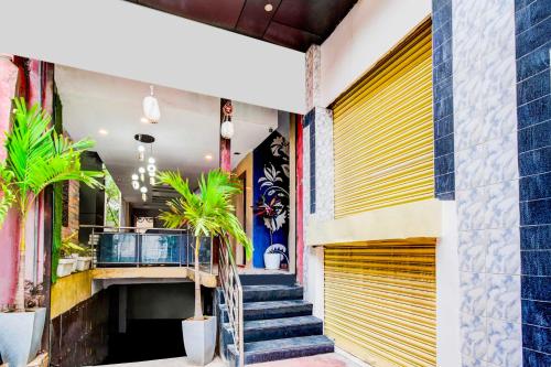 a building with stairs and a yellow garage door at Hotel O Isckon Temple in Hyderabad