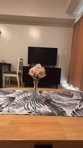 a vase of flowers sitting on top of a table at DH Suites in Manila