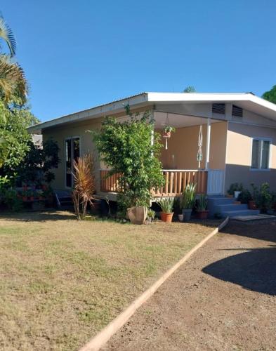 a house with a porch and some plants at Fare Tetua in Punaauia