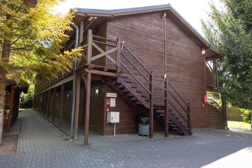 a building with a staircase on the side of it at Ośrodek Rehabilitacyjno Wypoczynkowy Bursztyn in Jantar