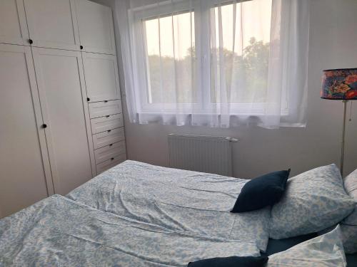 a bedroom with a bed and a window at Apartament Blisko Starego Miasta in Gdańsk
