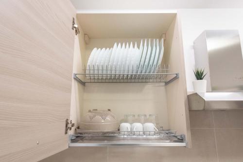 a cupboard with a tea kettle and vases at Il Risveglio del Cavaliere Casa Vacanza in Gioia dei Marsi