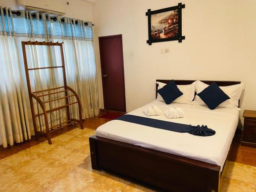 a bedroom with a bed and a chair in it at Sholay Villa in Galle