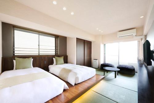 a hotel room with two beds and a window at montan HAKATA in Fukuoka