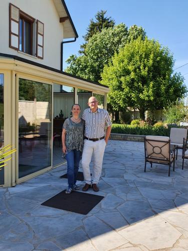 a man and woman standing in front of a house at Au Bon Vivant in Dampierre-sur-Salon