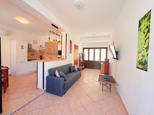 a living room with a couch and a kitchen at Casa Joe in San Vito lo Capo