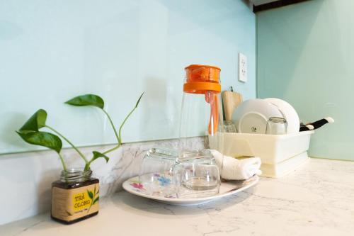 a counter with a plate and a bottle and a plant at Jade house Nguyễn Thị Minh Khai in Ho Chi Minh City