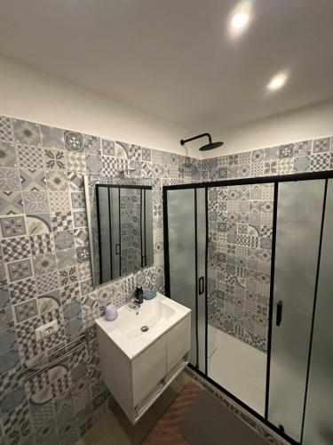 a bathroom with a white sink and a shower at YouRoominRome in Rome