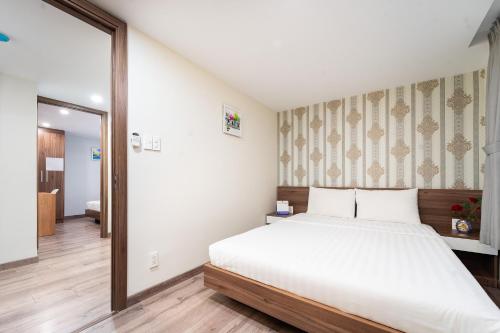 a bedroom with a bed and a large mirror at Jade house Nguyễn Thị Minh Khai in Ho Chi Minh City