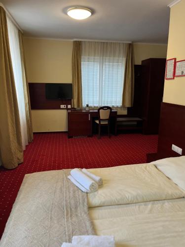 a hotel room with a bed with two towels on it at Prenočišča Zvezda in Ljutomer