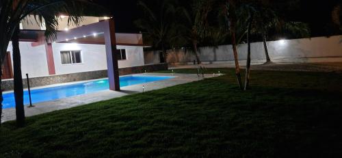 a house with a swimming pool at night at Casa Perez CCC in Juan Dolio
