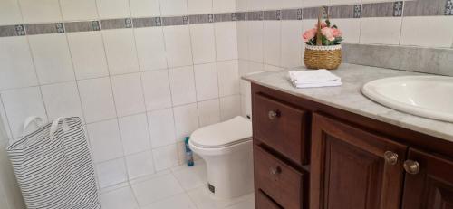 a bathroom with a sink and a toilet and a sink at Casa Perez CCC in Juan Dolio