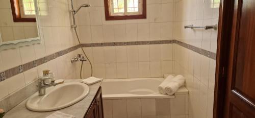 a white bathroom with a sink and a shower at Casa Perez CCC in Juan Dolio