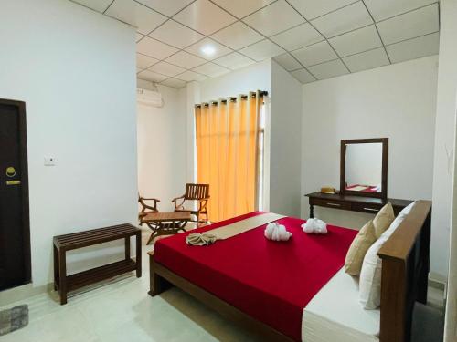 a bedroom with a bed with two towels on it at Sholay Villa in Galle