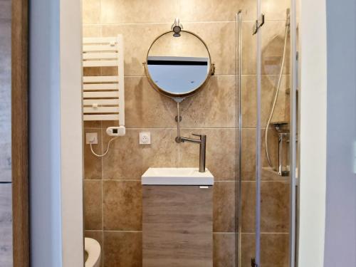 a bathroom with a sink and a mirror at Appartement, terrasse plage, Mmm in Antibes