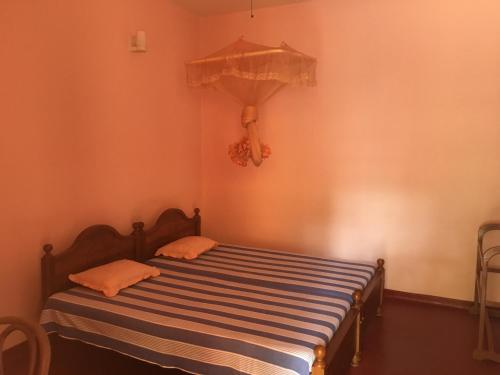 a bed in a corner of a room at Sunny Lanka Guest House in Matara