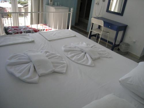 a white bed with towels on top of it at Cavo Christo in Petra