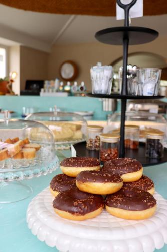 a plate of chocolate covered donuts on a table at Hôtel Océan in Capbreton