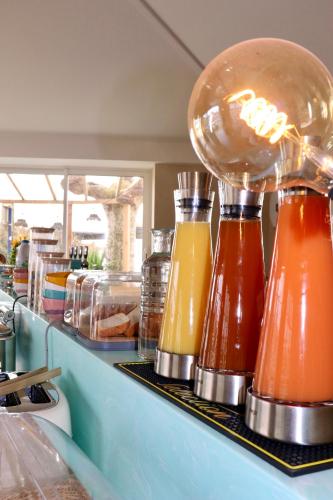 a counter with many bottles of condiments on it at Hôtel Océan in Capbreton