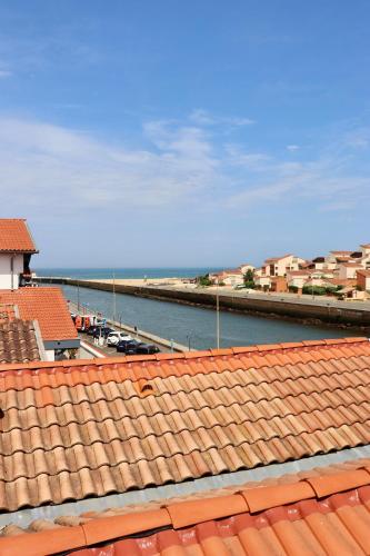 a view of the water and roofs of a harbor at Hôtel Océan in Capbreton