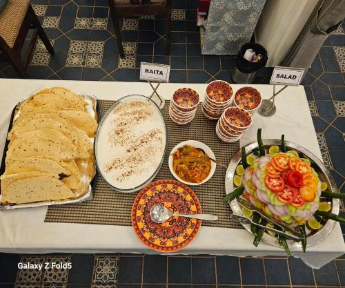 a table with different types of food on it at Crystal Retreat in Jāmb