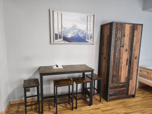 a table and stools in a room with a mirror at Przystań in Stalowa Wola