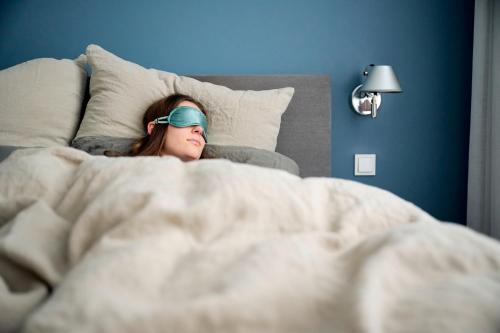Una cama o camas en una habitación de Hotel Aquamarin