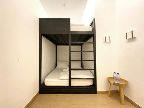 a black bunk bed in a room with a table at ManukabyHavis Boutique Hotel in Nagoya