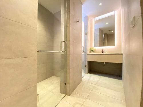 a bathroom with a shower with a sink and a mirror at ManukabyHavis Boutique Hotel in Nagoya