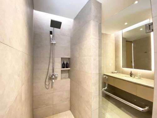 a bathroom with a shower and a sink at ManukabyHavis Boutique Hotel in Nagoya