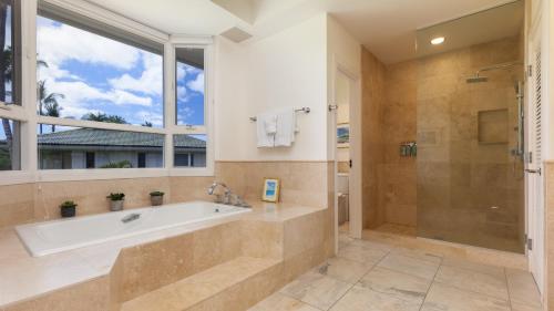 a bathroom with a tub and a shower and a window at ❤PiH❤ Island Melody Villa Stunning Views Free Resort Passes Bikes in Waikoloa