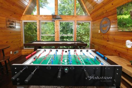 a pool table in a room in a log cabin at Patriots Den in Gatlinburg