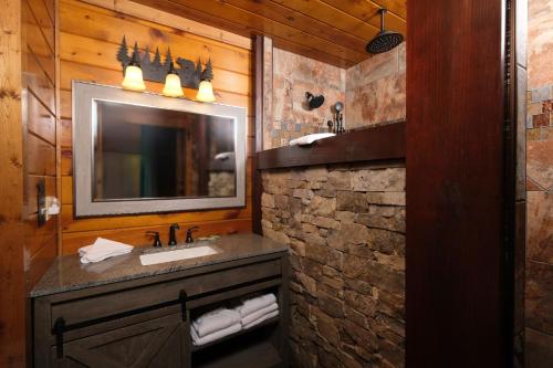 a bathroom with a sink and a mirror at Patriots Den in Gatlinburg