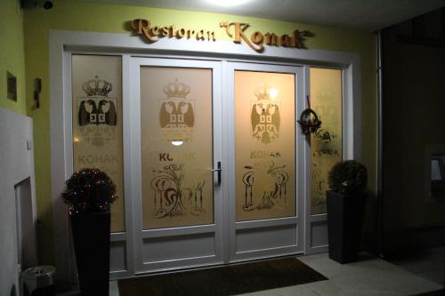 a front door of a restaurant with a sign above it at Konak Požarevac in Požarevac
