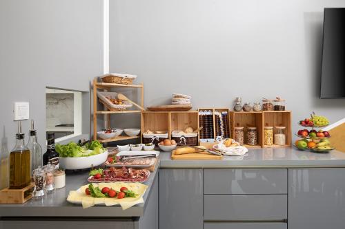 a kitchen counter with a bunch of food on it at Valbrione - Luxury Rooms & Suites in Valbandon