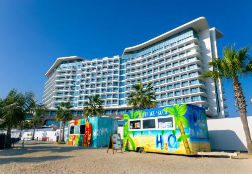 a bus parked in front of a large building at Hampton by Hilton Marjan Island in Ras al Khaimah
