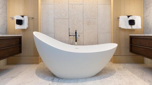a large white bath tub in a bathroom at ❤PiH❤ Hapuna Beachfront Bliss Beachfront Steps From Ocean B29 in Hapuna Beach