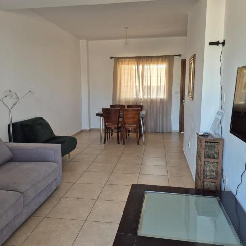 a living room with a couch and a table at King's Holiday Apartments in Paphos City