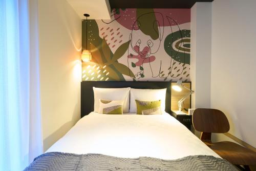 a bedroom with a bed with a white bedspread at Hotel Resol Ueno in Tokyo